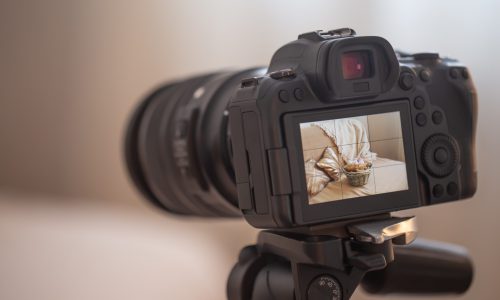 Close up professional digital camera on a tripod on a blurred background. The concept of technology for working with photos and videos.